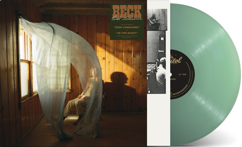Image of Beck sitting on a chair in a room with wood paneling walls and an open window with curtains blowing inward. Beck Ride Lonesome sticker on top right corner of room. Vintage green vinyl record peeking out of the side of the sleeve.