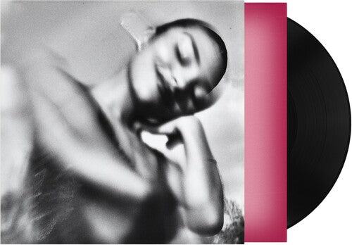 Olivia Dean "The Art of Loving" album cover featuring a black & white image of Olivia Dean, shown with a pink inner sleeve and a black vinyl record