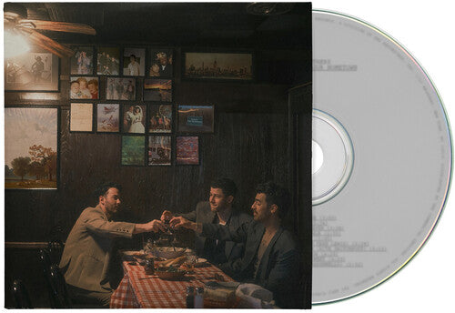 Jonas Brothers "Greetings From Your Hometown" CD cover with a scene of the three brothers at a table, surrounded by framed pictures on the wall. Shown with a white CD.