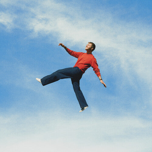 Alex Warren - Wildchild album cover, featuring Warren suspended in a cloudy blue sky