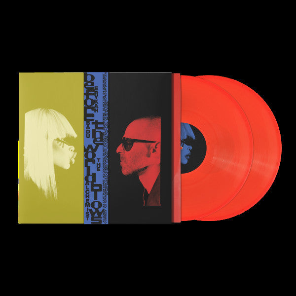 A vinyl record album shown against a black background, with the sleeve partially open to reveal two translucent red-orange records. The sleeve artwork features a split design: a yellow side with a profile image of Erykah Badu in sunglasses and a red/black side with a profile image of The Alchemist in sunglasses, and a blue vertical band with text.
