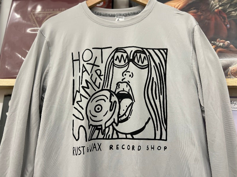 close up of the "Hot Wax Summer" logo printed in black ink on the front of a light grey colored long sleeve shirt