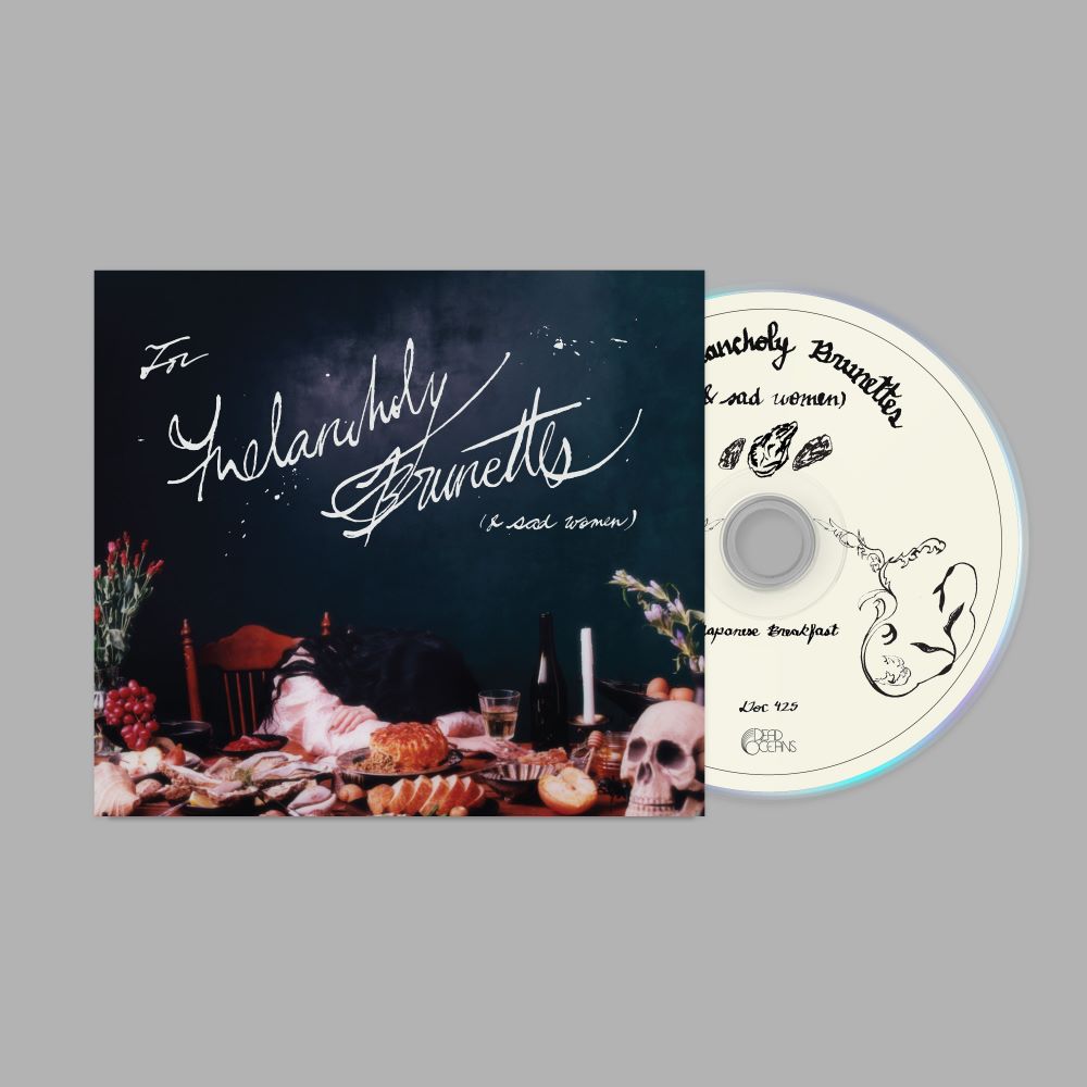 Japanese Breakfast "Melancholy Brunettes (& sad women)" album cover shown with a white CD with black text