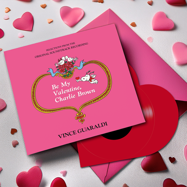 Vinyl record with pink cover featuring 'Be My Valentine, Charlie Brown' text, surrounded by heart-shaped decorations, shown with a red heart shaped vinyl record.