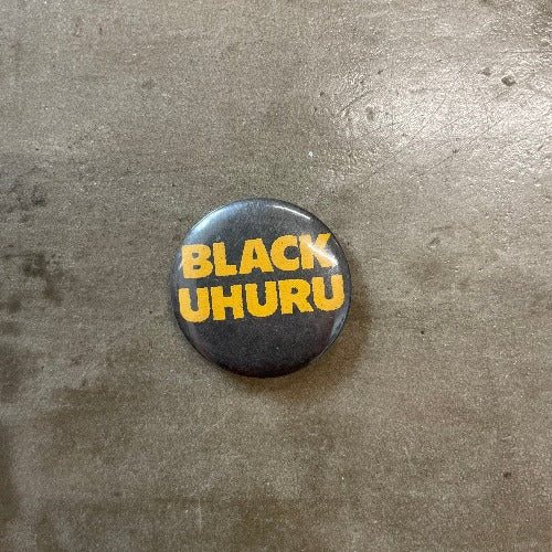 Black Uhuru Pin Front yellow text on black