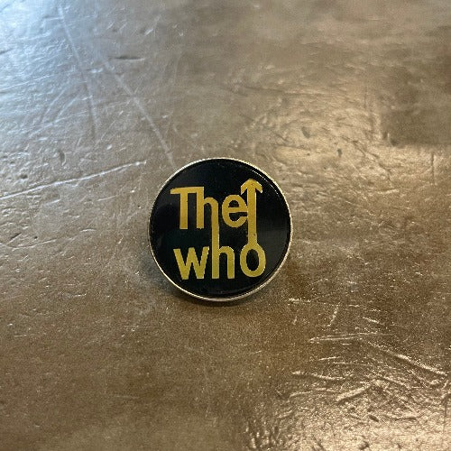 The Who Enamel Pin Gold Text against Black Backdrop