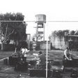 Cover for Royal Headache album showing black and white photo of the band playing behind a chain link fence in front of a tree and water tower.
