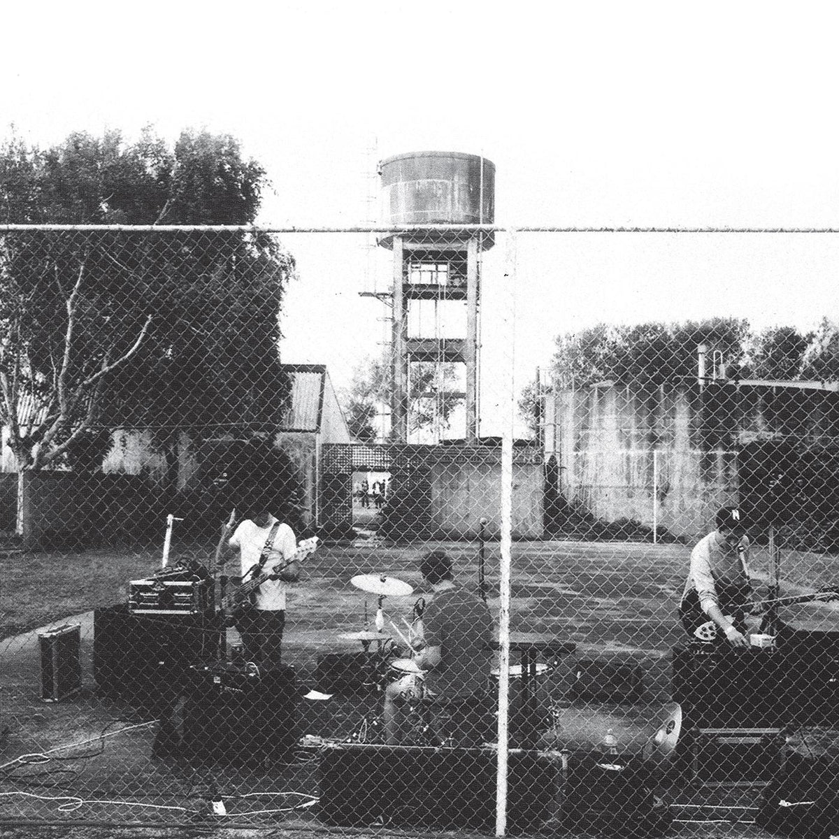 Cover for Royal Headache album showing black and white photo of the band playing behind a chain link fence in front of a tree and water tower.