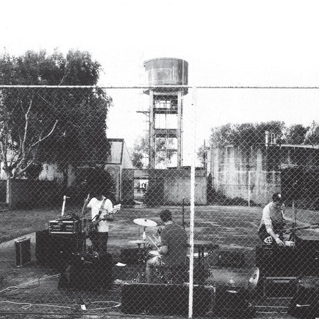 Cover for Royal Headache album showing black and white photo of the band playing behind a chain link fence in front of a tree and water tower.
