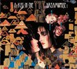 Album cover with text at the top reading 'A Kiss In The Dreamhouse' and 'Siouxsie And The Banshees' above images of the band surrounded by abstract art designs.