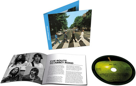 The Beatles - Abbey Road Anniversary CD cover, inner booklet and CD with a green apple printed on it shown on a white background