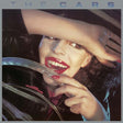 The Cars self-titled album cover with a person holding a steering wheel, featuring the text 'The Cars'.