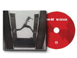 Album cover with a black and white photo of a person jumping from one building to another, and a red disc labeled mos def 'The Ecstatic'.
