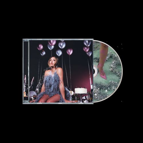 CD album cover for Hilary Duff Holiday Things showing Duff sitting in front of some silver and purple balloons. Green and silver designed CD sticking out the right side of the sleeve.