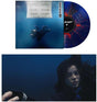 Billie Eilish "hit me hard and soft" album cover shown with a blue vinyl record with orange splatter
