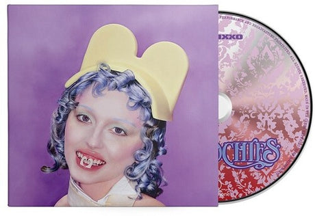 Ashnikko "Smoochies" album cover shown with a CD featuring a light red and white floral pattern on it.