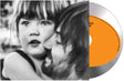 Tame Impala "Deadbeat" album cover featuring Kevin and his daughter, shown with a silver CD with an orange color blob in the middle.