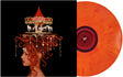 Record sleeve with image of woman with curly red hair with charms hanging off the curls and a merry go round on top of her head, set against a black backdrop and an orange vinyl record sticking out the side of the sleeve