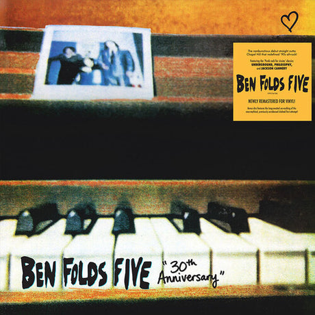 Close up image of piano keys with 'Ben Folds Five 30th Anniversary' text on white keys, a blurry photo of the band on top left corner of image, and hype sticker for the album on top right corner.