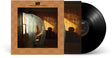 A vinyl record album shown with its outer cover and inner sleeve. The cover has a warm tan background with a central square photo of a dimly lit wooden room and a sheer white curtain partially covering Beck sitting in a chair.