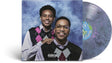 A vinyl record album shown with its front cover and a translucent marbled record partially visible. The cover features Cordae and Anderson. Paak in argyle vests against a blue marbled backdrop, with a Parental Advisory label at the bottom.