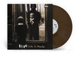 Album cover showing small child looking in the mirror with "Korn Life Is Peachy" text at bottom of the sleeve and brown "hardwood" colored vinyl record sticking out of the side of the sleeve.