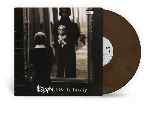 Album cover showing small child looking in the mirror with "Korn Life Is Peachy" text at bottom of the sleeve and brown "hardwood" colored vinyl record sticking out of the side of the sleeve.