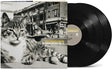 vinyl album cover showing a black and white image of a cat in front of a cityscape and car, with yellow text "Billy Bragg & Wilco' and white text "Mermaid Avenue Vol. II" and two black vinyl records sticking out of the side of the sleeve