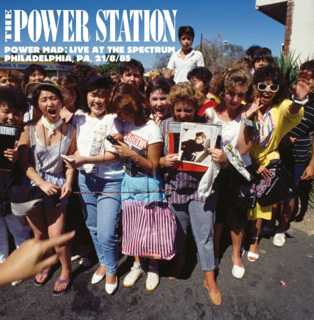 Group of people at a concert with 'The Power Station Live at the spectrum philadelphia' album cover