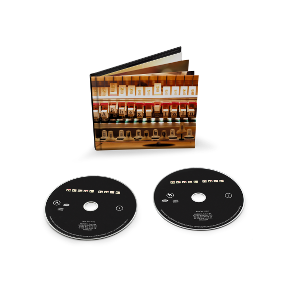 Two black CDs with CD sleeve behind them showing the inner workings of a piano.