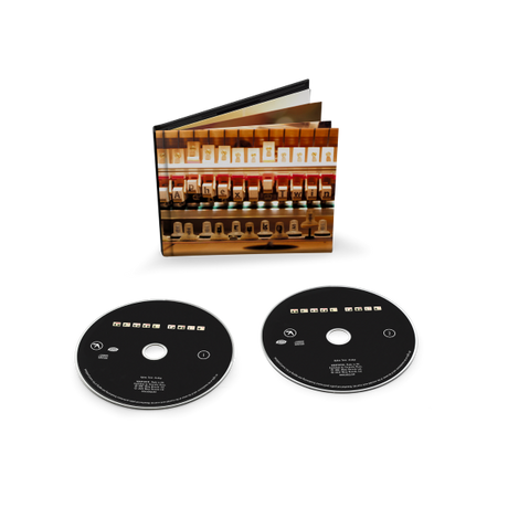 Two black CDs with CD sleeve behind them showing the inner workings of a piano.