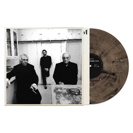 Charli XCX "Music, Fashion, Film" album cover featuring a black and white photo of three people on the cover. Shown with a marbled smoke colored vinyl record.