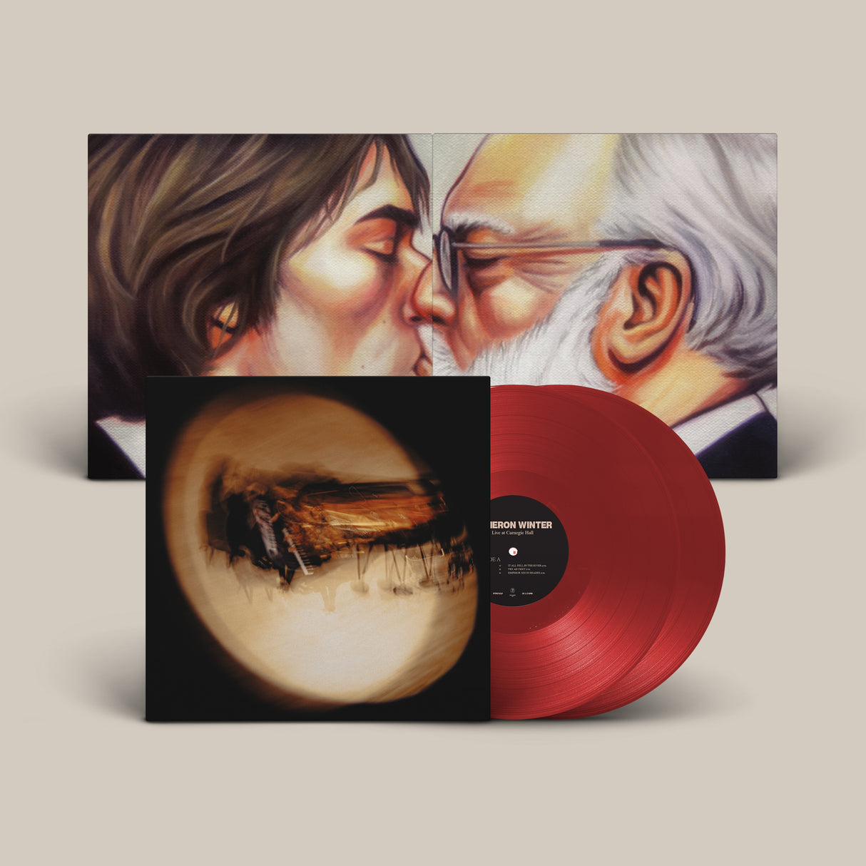 Album cover for Cameron Winter Live at Carnegie Hall featuring a blurry out of focus image of Winter at the piano on the front cover, artist rendering of Winter and an old man kissing inside the gatefold, and two red vinyl records sticking out the side of the sleeve