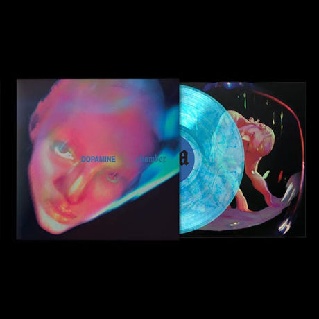 A vinyl record album shown open to reveal the cover art and the translucent blue record inside. The cover features a stylized neon-toned face with the text 'DOPAMINE' and 'chamber'.