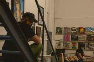 Image of Rust & Wax Record Shop owners, Melanie & Jesse Feldman, behind the counter of the shop.