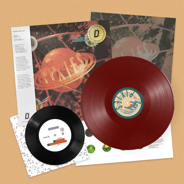 Pixies "Bossanova" album cover with white obi strip and a gold foil sticker. Shown with a red vinyl record and a black 7" record laid over top of the sleeves.