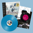 Pixies "Trompe le monde" album cover featuring a black obi strip. Shown with a sky blue vinyl record, plus a black 7"record laid over a white inner sleeve.