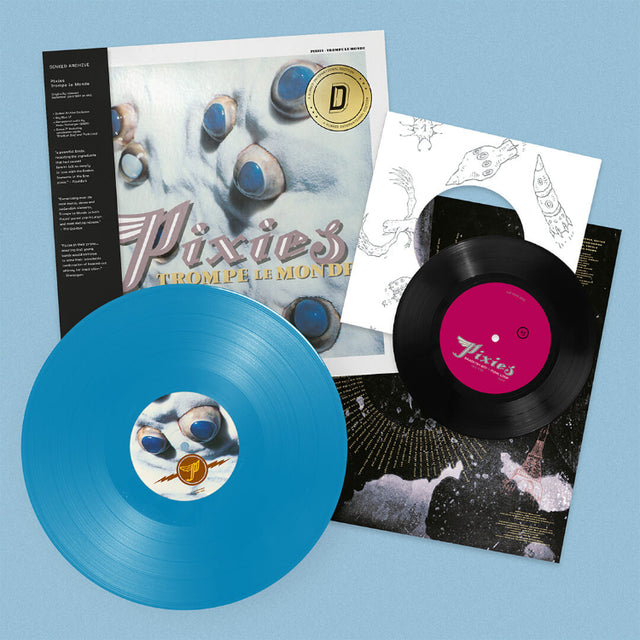 Pixies "Trompe le monde" album cover featuring a black obi strip. Shown with a sky blue vinyl record, plus a black 7"record laid over a white inner sleeve.