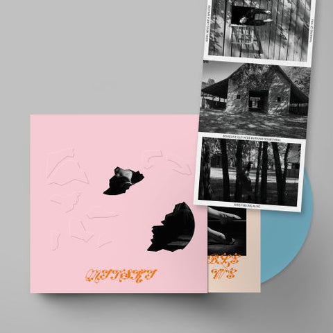 Mitski - The Land Is Inhospitable and So Are We baby pink album slipcase shown with baby blue vinyl record and series of 3 postcards