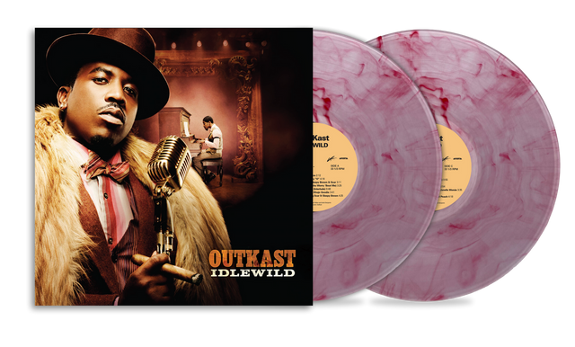 Album cover for Outkast Idlewild depicting Big Boi in a suit and fur coat holding a microphone and Andre 3000 sitting at a piano further back in the image of the cover. Two pink marbled vinyl records sticking out of the sleeve.