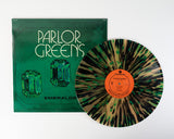 Parlor Greens 'Emerald' album cover featuring an emerald design, shown with a beer colored vinyl record with green and black splatter accents.