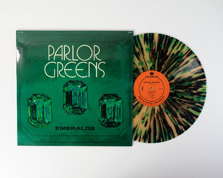 Parlor Greens 'Emerald' album cover featuring an emerald design, shown with a beer colored vinyl record with green and black splatter accents.