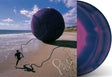 Phish "Slip Stitch and Pass" album cover featuring a beach scene and a person holding yar shown with two purple and blue swirl colored vinyl records.