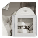 Taylor Swift "The Tortured Poets Department" CD album cover shown with white CD and poster in the background