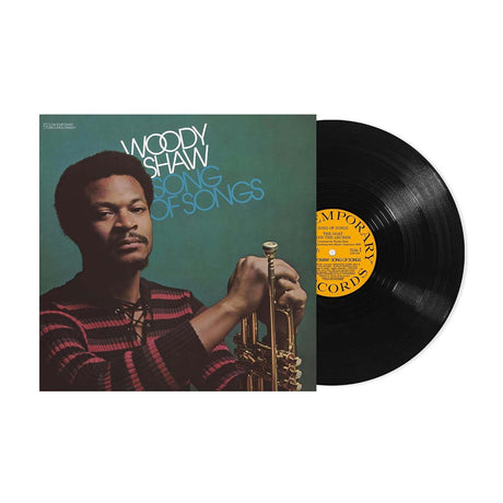 Woody Shaw 'Songs of Songs' vinyl record album with image of Woody Shaw in a striped shirt holding a trumpet and the black LP record partially visible on the right against a white background.