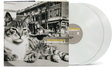 vinyl album cover showing a black and white image of a cat in front of a cityscape and car, with yellow text "Billy Bragg & Wilco' and white text "Mermaid Avenue Vol. II" and two white vinyl records sticking out of the side of the sleeve