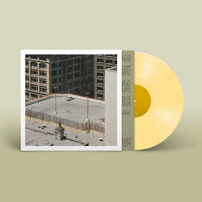 Arctic Monkeys - The Car album cover shown with custard yellow colored vinyl record