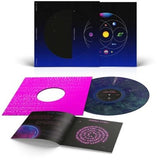 Coldplay - Music of the spheres album cover with blue/green colored vinyl record in a pink sleeve, with booklet