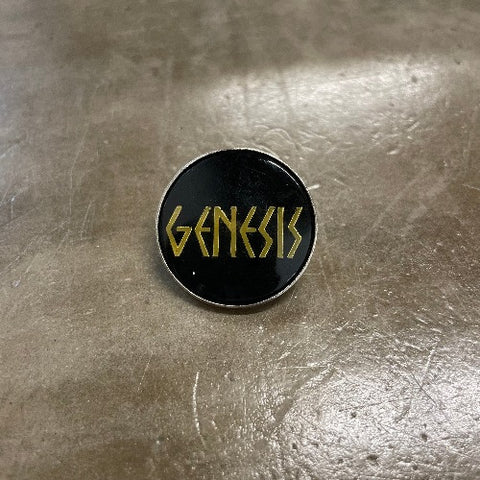 Genesis Enamel Pin Gold text on black backdrop