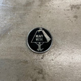 Heavy Metal Enamel Pin - Black Backdrop with person holding large weight with "Heavy Metal" text inside weight